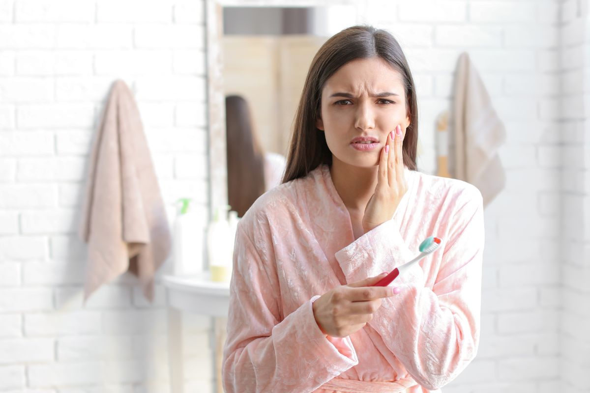 Young Woman Suffering From Toothache in Bathroom
